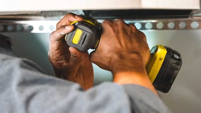 person-fixing-home-shelfing