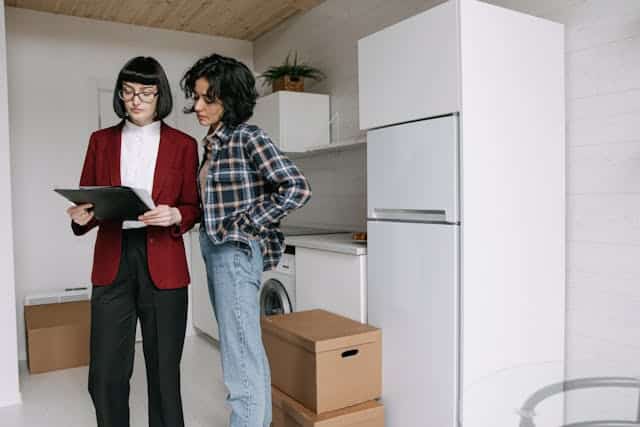 two-people-in-home-looking-at-papers