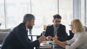 three people talking at a table