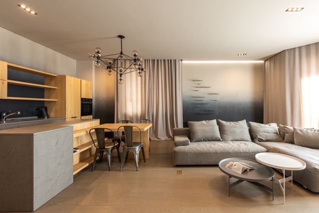 a contemporary living room with an open kitchen