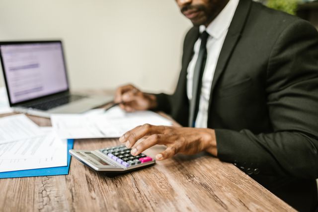 person making calculations at a desk